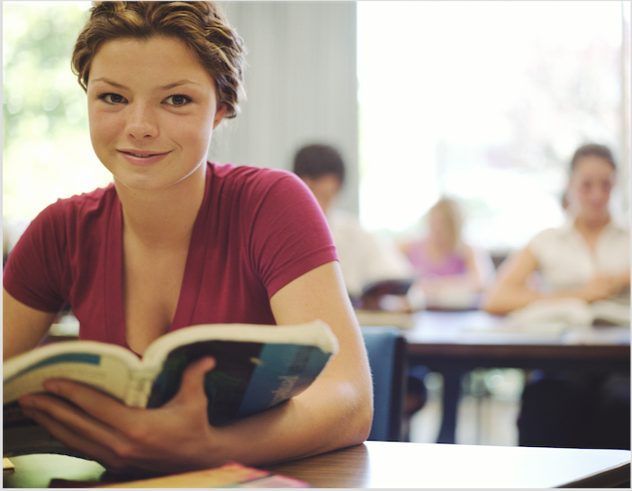 girl-reading-book-classroom