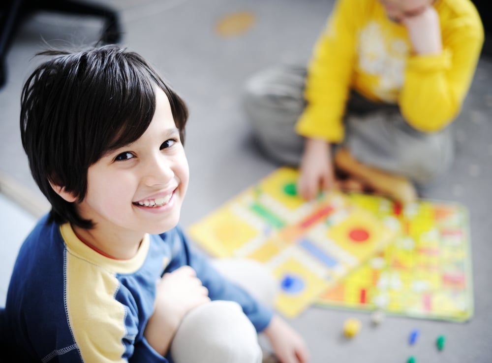 Two kids playing a game of cards