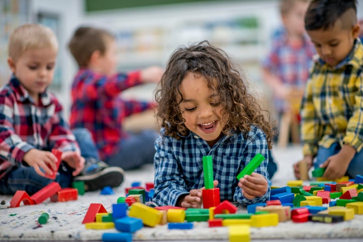 child with autism playing with blocks