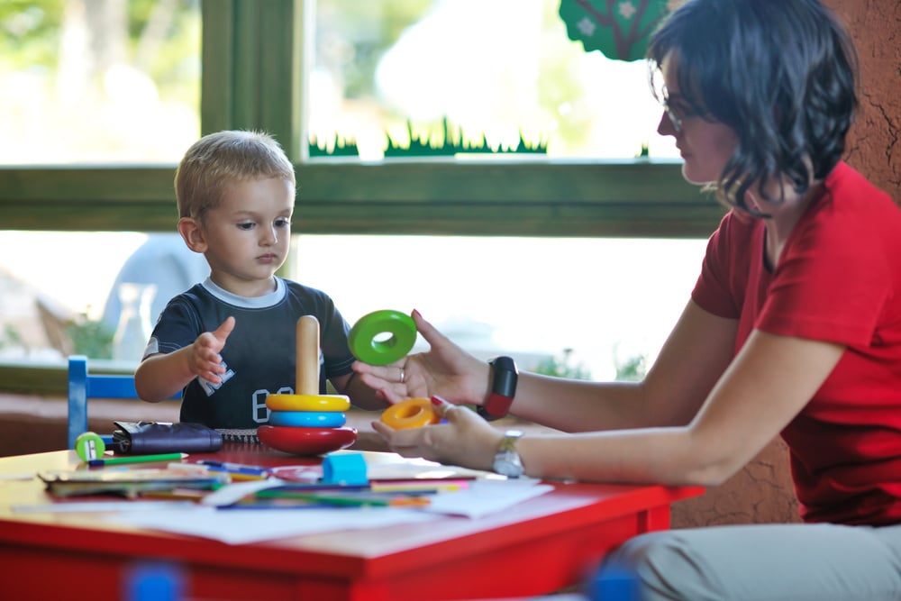 happy little child play game and have fun, education lessons in colorful kinder garden playground indoors