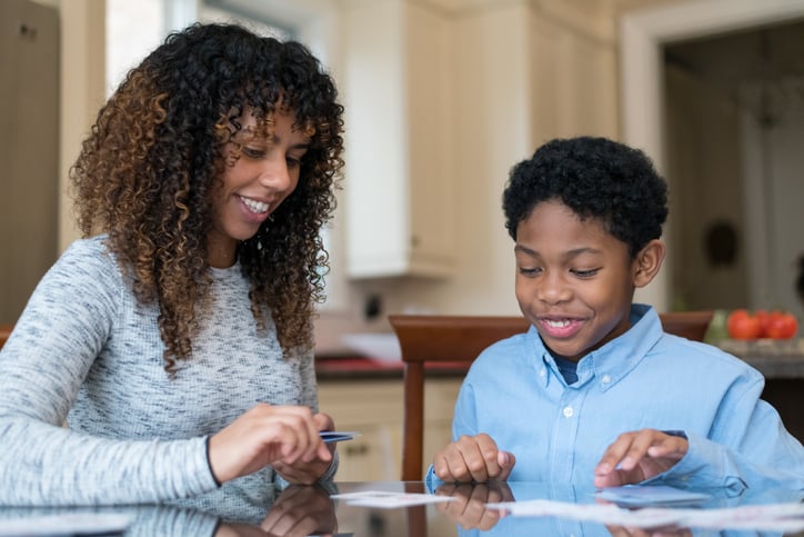 parent and child with autism looking at flash cards