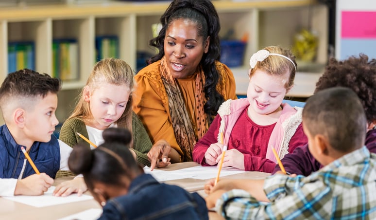 teacher with a group of students in an autism classroom