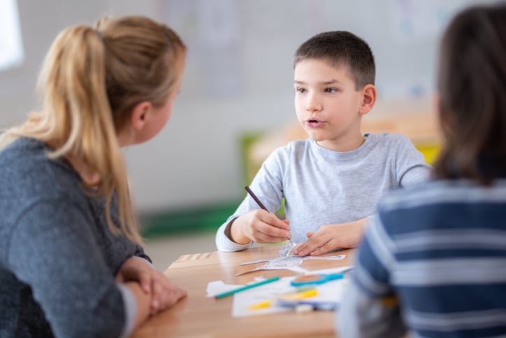 teacher supporting boy with autism